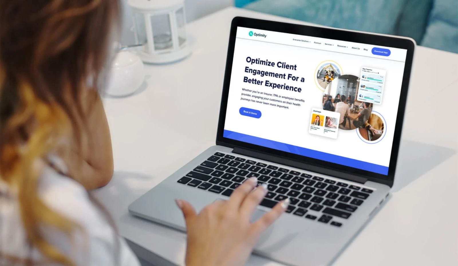 The live Optimity homepage open on a laptop, with the headline Optimize client engagement for a better experience.
